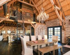 a dining room table with chairs and a chandelier hanging from it's ceiling