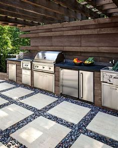 an outdoor kitchen with stainless steel appliances