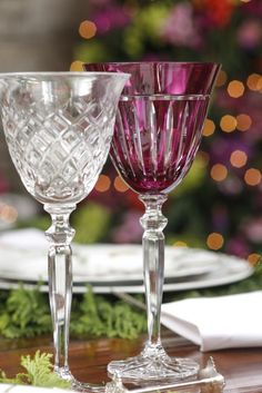 two wine glasses sitting on top of a wooden table