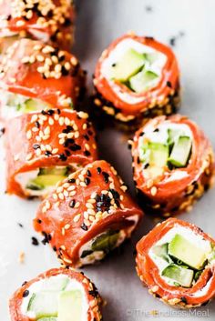 sushi rolls with cucumber and sesame seeds on top are ready to be eaten