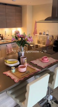 a kitchen counter with flowers and plates on it