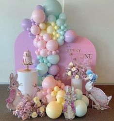 there are balloons and other items on the table for a birthday party or baby's first birthday