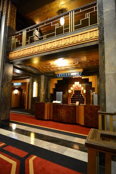 the inside of a building with red and black carpet