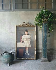 there is a painting on the wall next to a potted plant