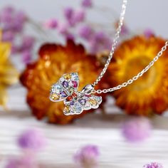 Flutter into spring with this colorful ombre necklace. Butterflies always remind us to pause and notice the world around us. Featuring rubies, amethysts, aquamarines and multi brilliant colorful stones, our silver butterfly necklace catches your eye with its exquisite sparkle. This necklace truly has us all aflutter for butterflies.Carat Weight: 10.55 ctStone Size: 1,1.3,1.5,1.8,2*3,2*3,2*3,2*3,2*3,2*3 mmStone Type: Jeulia® StoneNumber of Stones: 30 Stone Shape: Round, PearStone Color: Diamond W Sterling Silver Butterfly Necklace For Anniversary, Elegant Multicolor Butterfly Necklace As A Gift, Elegant Sterling Silver Butterfly Necklace In Yellow Gold, Elegant Multicolor Butterfly Necklace As Gift, Multicolor Butterfly Jewelry Gift, Multicolor Butterfly Jewelry For Gifts, Yellow Gold Sterling Silver Butterfly Necklace, Elegant Multicolor Jewelry With Butterfly Charm, Elegant Multicolor Butterfly Necklace Gift