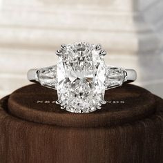 an oval cut diamond ring with baguettes on top