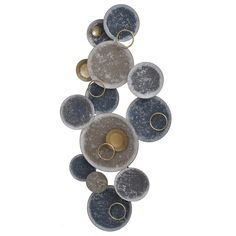 a wall hanging with several different colored circles and gold rings on the bottom one circle