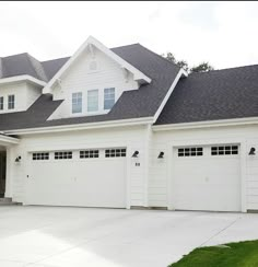 a large white house with two garage doors