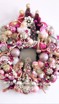 a christmas wreath with barbie dolls and ornaments