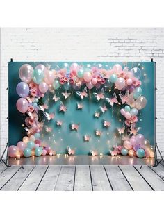 the backdrop is decorated with balloons and stars