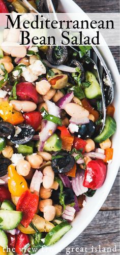 a white bowl filled with lots of different types of food on top of a wooden table