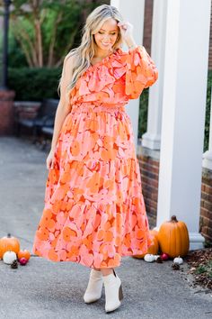 Get ready to feel the love from above in this stunning one shoulder orange floral dress! Show off your style and embrace the bold floral print! The smocked waistline provide a flattering fit, while the tiered skirt and elastic puff sleeve add a touch of playful charm! Love at first sight guaranteed! Shell & Lining - 100% Polyester Orange Floral Dress, Bold Floral Print, Jumpsuit Party, Dress Orange, Love At First, Fall Shopping, Love At First Sight, Dress With Cardigan, Tiered Skirt