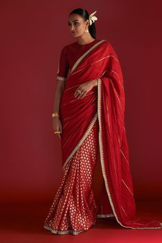 Red saree with all-over honeycomb foil prints, embellished borders, edged with kinari and crushed palla with gota work. Comes with paan-patti motif embroidered blouse piece.
Components: 2
Pattern: Embroidered, Foil Printed
Type Of Work: Paan-patti Motif, Honeycomb Patterns
Fabric: Raw Silk
Color: Red
Other Details: 
Note: Stitched blouse worn by the model is not for sale
Disclaimer: The actual print-placement and colour of the product may vary slightly from the image shown.
Occasion: Wedding - A Floral Print Sarees, Black Saree, Red Saree, Blouse For Women, Silk Organza, Party Wear Sarees, Saree With Blouse, Printed Sarees, Green Silk