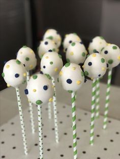 cake pops with green and white polka dots on them