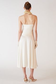 The Princess Silk Slip Dress is a luxurious tea-length dress crafted from 100% pure silk. Made in NYC, this dress features a flattering silhouette that gracefully drapes over the body, accentuating its wearer’s natural shape. With its delicate straps and timeless design, perfect for both formal occasions and chic, everyday wear. Orseund Iris offers a 14-day exchange & return policy for all items except for final sale pieces. Cream Silk Evening Midi Dress, Cream Silk Midi Dress For Evening, Elegant A-line Spring Slip Dress, Elegant Cream Slip Dress For Party, Silk A-line Midi Dress For Dinner, Delicate Fitted Evening Dress, Evening Slip Dress With Delicate Straps And Fitted Bodice, Pre-draped Spaghetti Strap Formal Dress, Silk Dresses With Delicate Straps