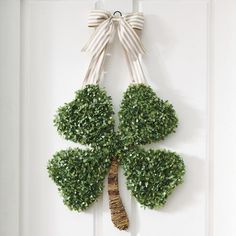 a four leaf clover shaped wreath hangs on the front door to give it a festive touch