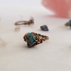 My wire wrapped crystal rings are the perfect accessory for any outfit. These genuine turquoise nuggets might be tiny, but they hold all the purification healing properties of any larger size turquoise stone such as dispelling negative energy and aligning your chakras. Steampunk meets boho chic; they resemble a robin's egg in a little nest. Mix and match and stack them with other rings to enhance their healing properties and personalize your style. The bands are twist braided by hand and the cry Spiritual Turquoise Ring For Healing, Spiritual Turquoise Ring With Natural Stones, Spiritual Wire Wrapped Crystal Ring, Turquoise Raw Stone Jewelry For Healing, Handmade Adjustable Turquoise Crystal Ring, Adjustable Turquoise Bohemian Crystal Ring, Spiritual Turquoise Healing Ring, Spiritual Healing Turquoise Ring, Bohemian Wire Wrapped Adjustable Crystal Ring