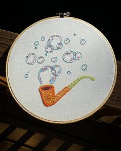 an embroidery project with a pipe and bubbles