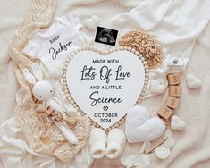 a white heart shaped ornament surrounded by other items on a blanket with the words made with love and a little science