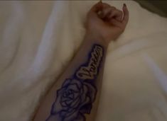 a person with a rose tattoo on their arm