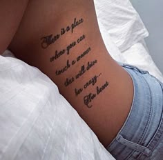 a woman laying in bed with a tattoo on her stomach that says, there is no place where you can expect to remain