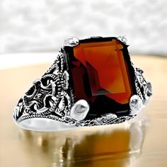 Step into a world of timeless elegance with our Vintage Vivid Red Simulated Garnet Solitaire Ring, beautifully crafted from exquisite 925 solid sterling silver. This striking ring features a stunning simulated garnet -- a vibrant red stone that captures the essence of passion and grace. The unique filigree design adds an extra layer of intricacy and charm, showcasing the craftsmanship that goes into every piece. Stamped with 925, you can be confident in the authenticity and quality of your purchase. This solitaire ring is not only a stylish accessory but also a versatile piece that can complement any outfit, from casual daywear to evening elegance. Available in multiple sizes, it ensures a perfect fit for anyone looking to add a pop of color to their jewelry collection. The vivid red color Classic Red Intaglio Jewelry, Formal Sterling Silver Filigree Ring With Intricate Design, Elegant Sterling Silver Intaglio Rings, Formal Engraved Filigree Ring In Sterling Silver, Heirloom Style Filigree Ring With Intaglio For Gift, Formal Engraved Sterling Silver Filigree Ring, Heirloom Filigree Ring With Intaglio For Gifts, Heirloom Intaglio Filigree Ring As Gift, Classic Sterling Silver Filigree Ring For Formal Occasions