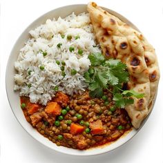 a white bowl filled with rice, peas and meat next to pita bread on top of it