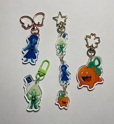 four different key chains with cartoon characters on them