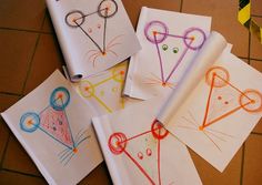 four children's handmade notebooks with drawings on them