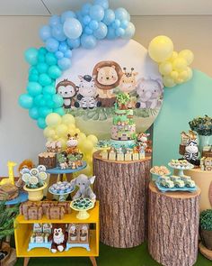 an animal themed birthday party with balloons and desserts