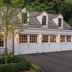 a two car garage with three windows on the top and one door open to let in light