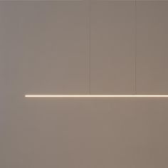 a white wall with some lights hanging from it