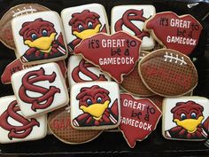 some decorated cookies in the shape of footballs with words that read it's great to be a gamecock