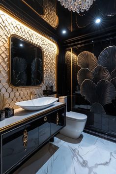 a fancy bathroom with black and gold decor, chandelier, toilet and sink