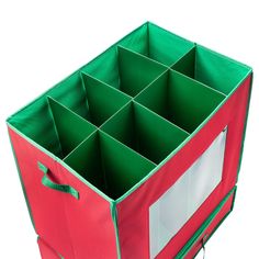 a red and green box with compartments on the bottom is shown in front of a white background