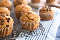 several muffins on a cooling rack with chocolate chips