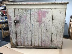 an old wooden cabinet sitting on top of a table