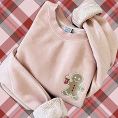 Get into the holiday spirit with our Pigment-Dyed Embroidered Gingerbread Man Sweatshirt, designed for coffee lovers who adore Christmas! This high-quality sweatshirt features an embroidered gingerbread man sipping on a delicious frappe, blending festive fun with cozy style. 🍪 Key Features: Premium Pigment-Dyed Fabric: Each sweatshirt is uniquely pigment-dyed for a rich, vintage-inspired color that softens with every wash, giving it a timeless, lived-in feel. Detailed Embroidered Design: The playful gingerbread man enjoying a cool frappe adds a whimsical holiday twist for coffee enthusiasts. Super Soft & Durable: Made from a high-quality cotton blend, this sweatshirt is perfect for keeping warm while looking stylish all season long. Festive & Fun: Perfect for Christmas gatherings, coffee Coffee Lovers Gift, Christmas Pullover, Gingerbread Cookie, Holiday Coffee, Cozy Style, Men Sweatshirt, Christmas Vibes, Disney Movie, Embroidered Clothes