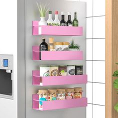 a pink shelf filled with lots of bottles next to a white microwave and potted plant