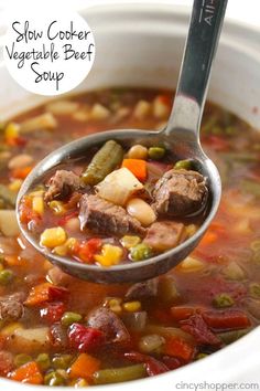 a spoon full of soup with meat and vegetables