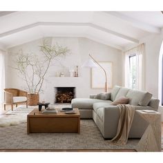 a living room filled with furniture and a fire place in the middle of the room