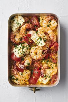 a casserole dish with shrimp and tomatoes