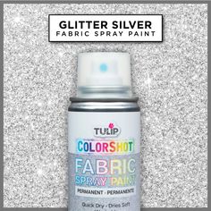 the spray paint is silver and has glitter on it, as well as an ad for fabric