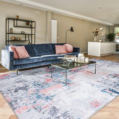 a living room filled with furniture and a large rug