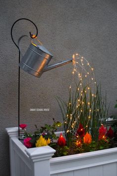 a potted planter filled with flowers and lights