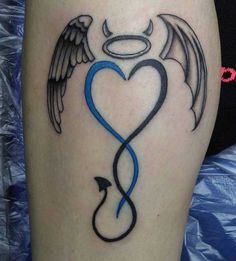 a heart with wings and an arrow tattoo on the leg