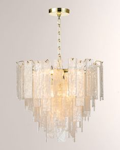 a chandelier hanging from the ceiling in a room with white walls and flooring