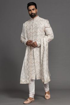 Elevate your wedding day look with this exquisite Ivory Zardosi Embroidered Raw Silk Sherwani. A timeless blend of traditional craftsmanship and modern elegance, perfect for the regal groom.✨💫 _____ _____ _____ PRODUCT CODE: SH1383 World Wide Free Shipping Mobile: +91-7829928490 _____ _____ _____ #WeddingSherwani #IvorySherwani #ZardosiEmbroidery #RawSilkSherwani #GroomFashion #LuxuryMenswear #TraditionalAttire #IndianGroom #WeddingStyle #SherwaniForMen #EthnicWear #BridalFashion #WeddingInspiration #Samyakk Pakistani Kurta Designs, Sherwani For Groom, Mens Indian Wear, Global Wedding, Pakistani Kurta, African Attire For Men