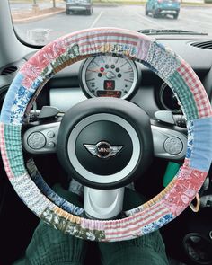 the steering wheel cover is decorated with colorful fabric