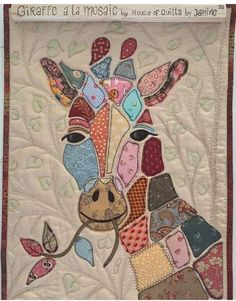 a close up of a quilt with a giraffe's face on it